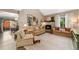 Bright living area with fireplace, sofas, neutral decor, and access to a dining area at 938 W Peakview Cir, Littleton, CO 80120