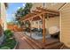 Inviting backyard patio with pergola, outdoor seating, a brick path, and a well-maintained landscaped yard at 938 W Peakview Cir, Littleton, CO 80120