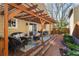 Relaxing patio with wooden pergola, comfortable seating, and brick path, perfect for outdoor entertaining at 938 W Peakview Cir, Littleton, CO 80120