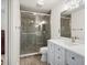 This bathroom features a shower with tile surround, and a white vanity with granite countertops at 10536 Garrison St, Westminster, CO 80021