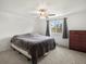 A bedroom features a double bed, gray carpet, and a window with natural lighting at 10536 Garrison St, Westminster, CO 80021