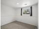 Cozy bedroom featuring neutral carpeting, white walls, and a bright window for natural light at 10536 Garrison St, Westminster, CO 80021