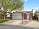 Charming single-Gathering home featuring an attached two-car garage, brick facade, and landscaped front yard at 10536 Garrison St, Westminster, CO 80021