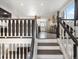 Foyer with stairs to the second floor and view to the kitchen with open floor plan, natural light at 10536 Garrison St, Westminster, CO 80021