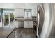 The kitchen is equipped with stainless appliances, white cabinetry, and access to the back deck at 10536 Garrison St, Westminster, CO 80021