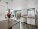 Bright kitchen features stainless appliances, white cabinets, wood floors and countertops, and a view to the deck at 10536 Garrison St, Westminster, CO 80021