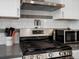 This updated kitchen features a stainless steel gas range, microwave and white subway tile at 10536 Garrison St, Westminster, CO 80021