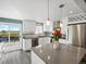Modern kitchen with stainless appliances, gray countertops, pendant lights, and sliding glass door to the deck at 10536 Garrison St, Westminster, CO 80021