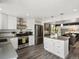 Modern kitchen with stainless appliances, gray countertops, pendant lights, and open to the living room at 10536 Garrison St, Westminster, CO 80021
