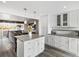 Open-concept kitchen with an island featuring an eat-in breakfast bar and seamless access to the living area at 10536 Garrison St, Westminster, CO 80021