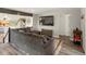Bright living room with gray couch, flat screen TV, and view to the kitchen with open floor plan at 10536 Garrison St, Westminster, CO 80021