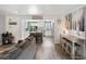 Open concept living room featuring a gray couch, view to kitchen with bright, natural light at 10536 Garrison St, Westminster, CO 80021