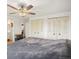 Bright main bedroom featuring spacious closets, a ceiling fan, and ensuite bath at 10536 Garrison St, Westminster, CO 80021