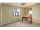 Simple bedroom with a desk, chair, and window, suitable for a home office at 19326 E Greenwood Pl, Aurora, CO 80013