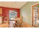 Bright dining area featuring a round wooden table, chairs, and sliding glass door to the backyard at 19326 E Greenwood Pl, Aurora, CO 80013