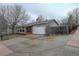 Exterior of home with a porch, brick accents, large tree, and a long driveway at 19326 E Greenwood Pl, Aurora, CO 80013