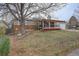 Ranch style house featuring a front porch, brick accents, and a well-maintained lawn at 19326 E Greenwood Pl, Aurora, CO 80013