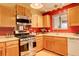 Kitchen with stainless steel appliances, wood cabinets, and a window over the sink area at 19326 E Greenwood Pl, Aurora, CO 80013