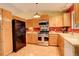 Well-equipped kitchen features stainless steel appliances, wood cabinets, and modern finishes at 19326 E Greenwood Pl, Aurora, CO 80013