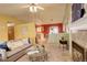 Open-concept living room featuring a fireplace, comfortable sofa, and views into the kitchen at 19326 E Greenwood Pl, Aurora, CO 80013