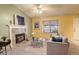 Bright living room with a cozy fireplace, plush seating, and ample natural light at 19326 E Greenwood Pl, Aurora, CO 80013