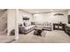 Spacious basement with a large sectional sofa, decor, and carpeted flooring at 6900 S Clermont St, Centennial, CO 80122