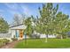 Exterior view showcasing the manicured lawn and lush landscaping surrounding this charming home at 6900 S Clermont St, Centennial, CO 80122