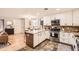 Well-lit kitchen boasts a functional island, stainless steel appliances, and ample cabinet space at 6900 S Clermont St, Centennial, CO 80122