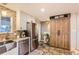 Bright kitchen includes stainless steel appliances, granite countertops, and custom wood cabinetry at 6900 S Clermont St, Centennial, CO 80122