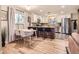 Sunlit kitchen with sleek appliances, granite countertops, and an adjacent dining area with seating at 6900 S Clermont St, Centennial, CO 80122