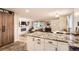 Open concept living space features a kitchen island, fireplace, and comfortable seating area at 6900 S Clermont St, Centennial, CO 80122