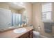 Neutral bathroom featuring a vanity, toilet, and shower/tub combination with a light blue shower curtain at 2558 Northview Pl, Castle Rock, CO 80104
