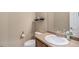 Cozy bathroom featuring a single sink vanity, toilet, and decorative wall shelf at 2558 Northview Pl, Castle Rock, CO 80104