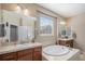 Bathroom featuring double vanities, a soaking tub, and natural light at 2558 Northview Pl, Castle Rock, CO 80104