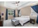 Bright bedroom with large windows, tray ceiling, neutral walls, and a ceiling fan at 2558 Northview Pl, Castle Rock, CO 80104