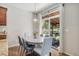 Dining room with wood floors, round table, and chairs with sliding door leading to the backyard at 2558 Northview Pl, Castle Rock, CO 80104