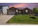 Charming brick home with a well-manicured lawn and professional landscaping at sunset at 2558 Northview Pl, Castle Rock, CO 80104