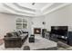 Comfortable living room with fireplace, ceiling fan, and large window overlooking the backyard at 2558 Northview Pl, Castle Rock, CO 80104