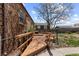 Expansive backyard with a wooden deck, trees, and adjacent brick building at 111 S Perry St, Denver, CO 80219