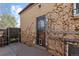 Small outdoor area with brick walls, ivy vines, and an iron security door at 111 S Perry St, Denver, CO 80219