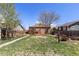 Large backyard featuring a wood deck with outdoor furniture, a firepit, and a well-maintained lawn at 111 S Perry St, Denver, CO 80219