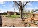 Landscaped backyard featuring a wooden deck, fire pit, shed, and plenty of space at 111 S Perry St, Denver, CO 80219