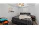 Well-lit bedroom with a ceiling fan, window, and queen sized bed at 111 S Perry St, Denver, CO 80219
