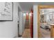 Hallway view of the red entry door, kitchen, and staircase at 111 S Perry St, Denver, CO 80219