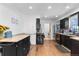 Spacious kitchen featuring dark cabinetry, butcher block countertops, and stainless steel appliances at 111 S Perry St, Denver, CO 80219