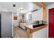 Bright kitchen with stainless steel appliances, wood countertops, and a breakfast bar at 111 S Perry St, Denver, CO 80219
