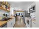 Bright and airy kitchen with white cabinets, stainless steel appliances, and wooden countertops at 111 S Perry St, Denver, CO 80219