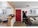 Open-concept living area featuring hardwood floors and a view of the red entry door at 111 S Perry St, Denver, CO 80219