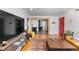 Open-concept living area flowing into the kitchen, featuring hardwood floors and modern decor at 111 S Perry St, Denver, CO 80219