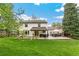 Expansive backyard featuring a spacious lawn, patio area, and outdoor seating, perfect for entertaining at 6712 S Leyden Ct, Centennial, CO 80112